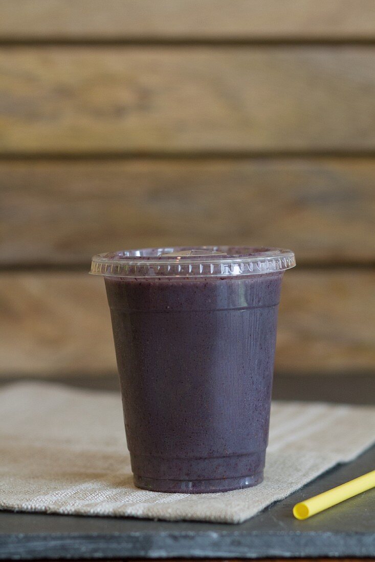 A smoothie made with coconut water, hibiscus tea, acai berries, strawberries, blueberries, B12, bananas and hemp seeds