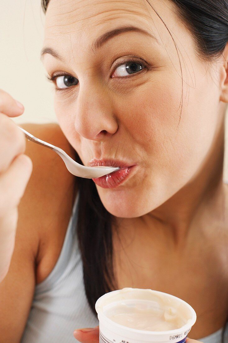 Woman eating yoghurt