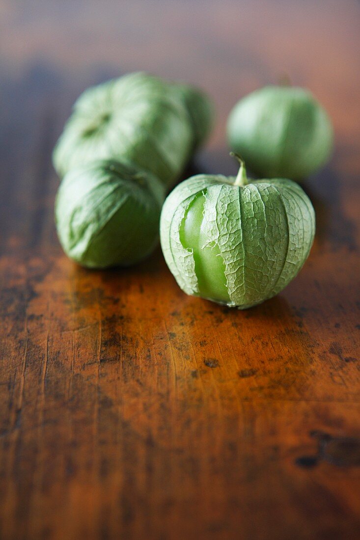 Tomatillos on a wooden surface
