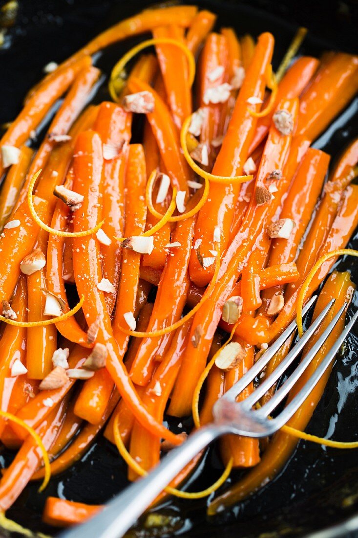 Carrots with orange glaze and candied pine nuts