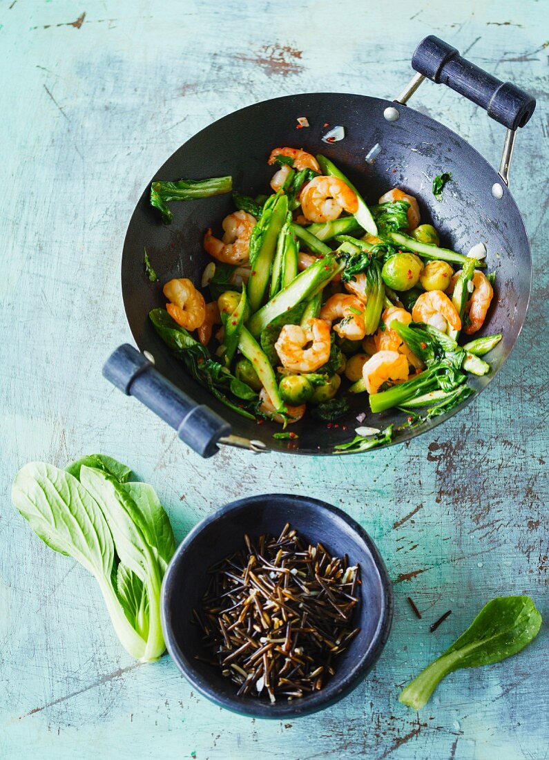 Stir-fried shrimps with green asparagus, bok choy and Brussels sprouts
