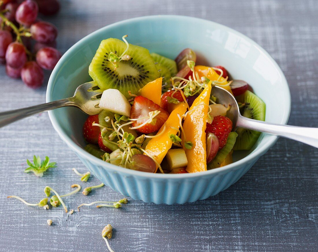 A colourful fruit salad with cereal sprouts