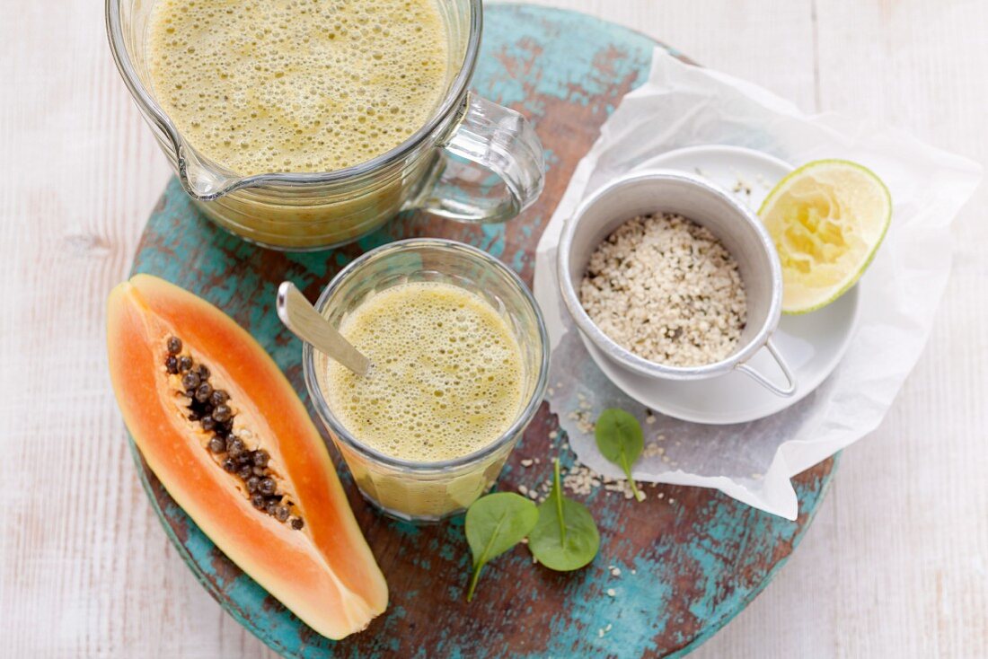 A papaya smoothie made with bananas, limes, spinach and hemp seeds