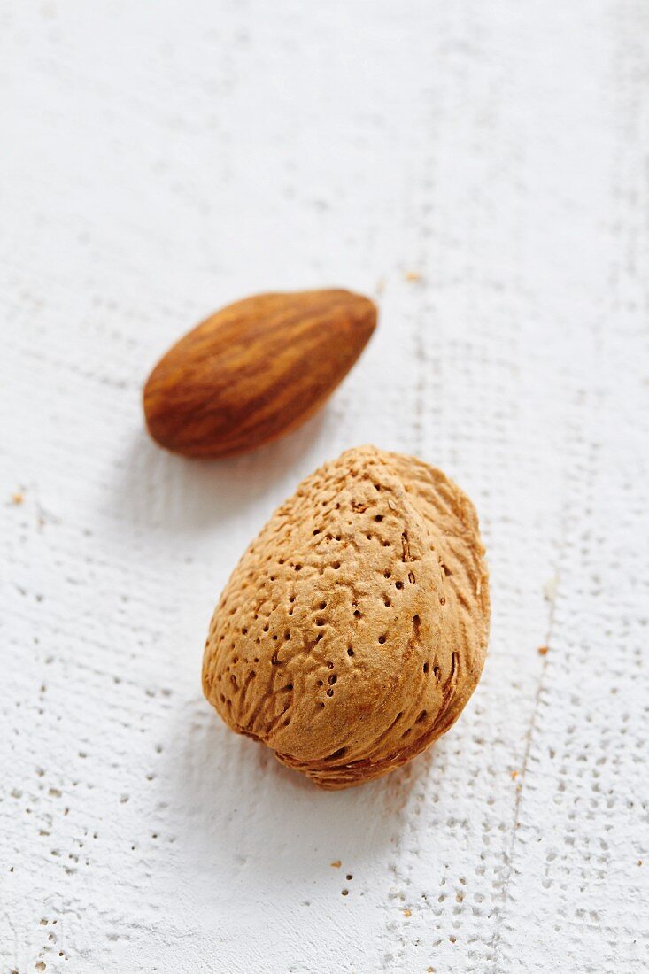 An unshelled almond and an almond