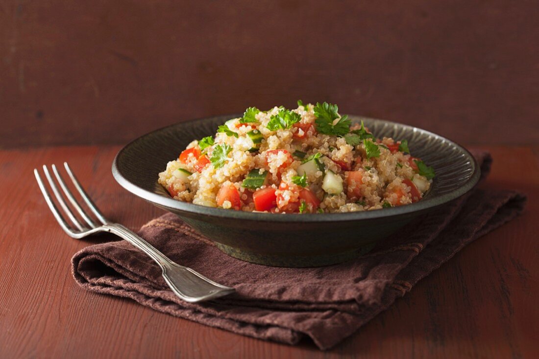 Quinoa salad with tomatoes, cucumber and parsley