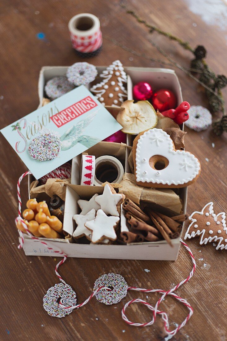 Various Christmas biscuits and Christmas decorations in an old box