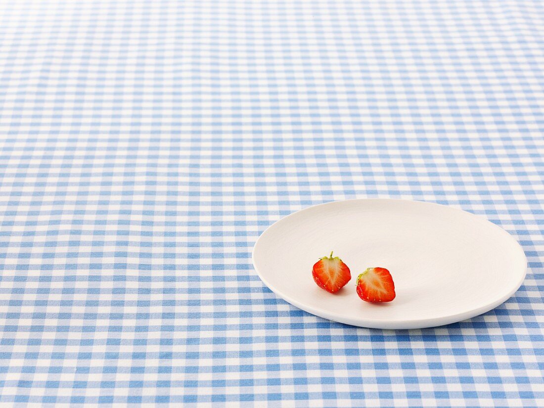 A halved strawberry on a plate