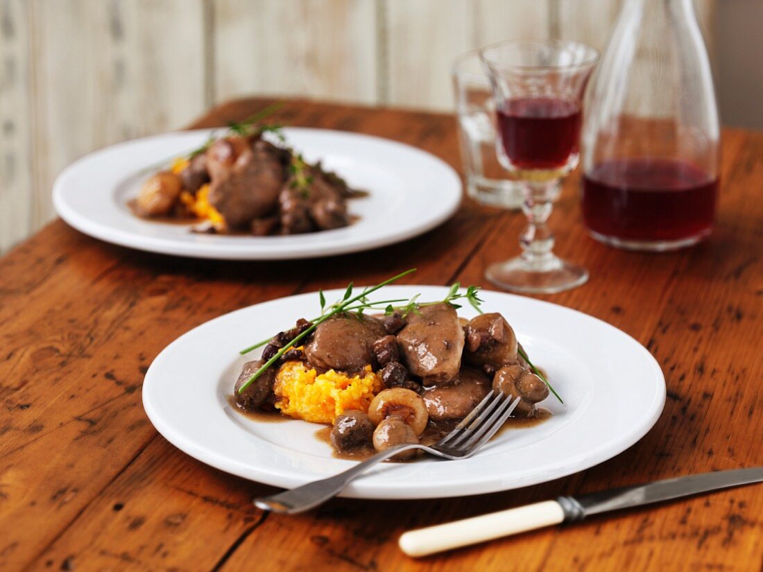 Coq au vin served on butternut squash purée with thyme and chives