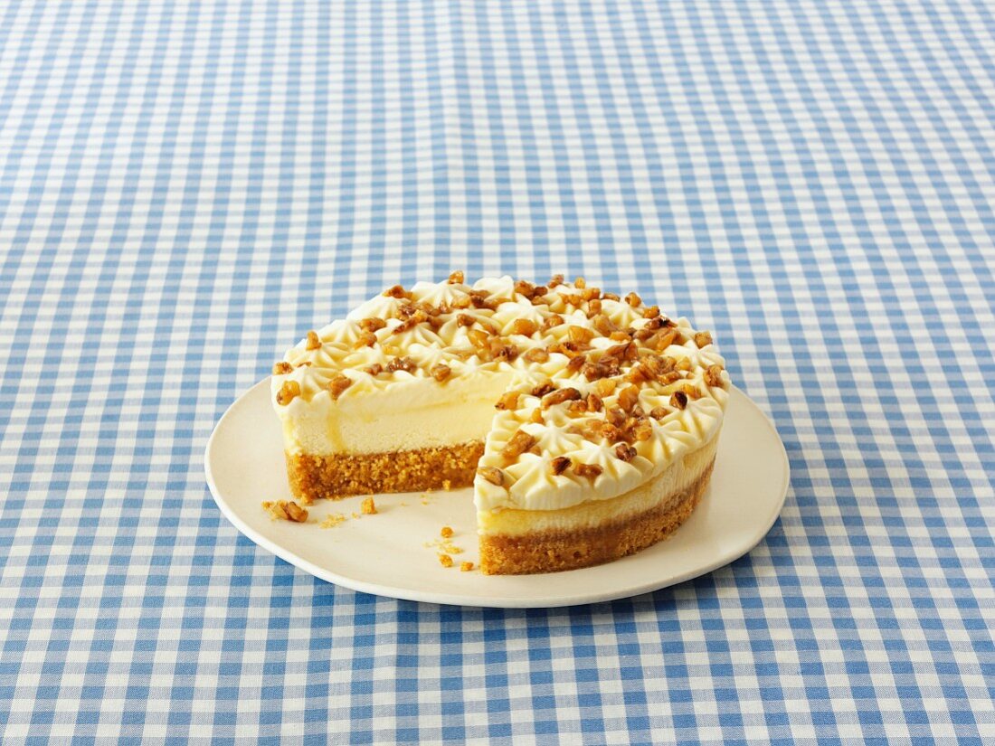 A cheesecake with walnuts and maple syrup, sliced