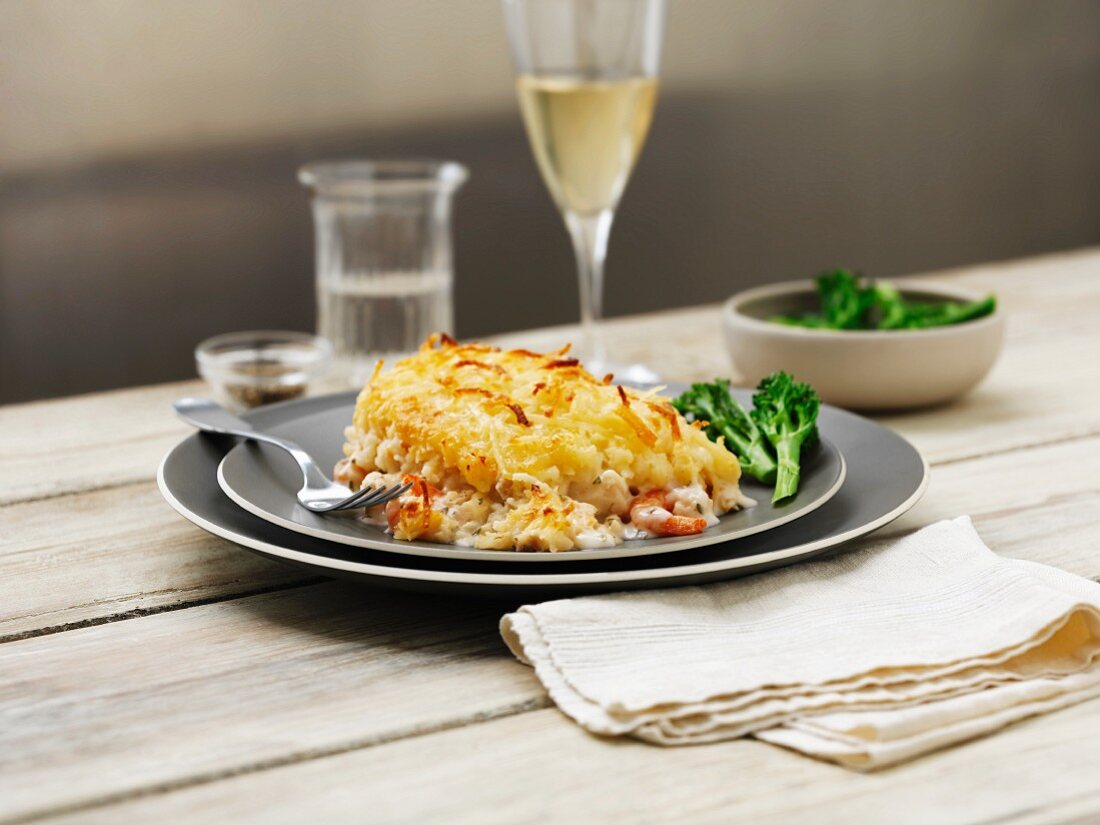 Mixed fish pie with broccoli and wine