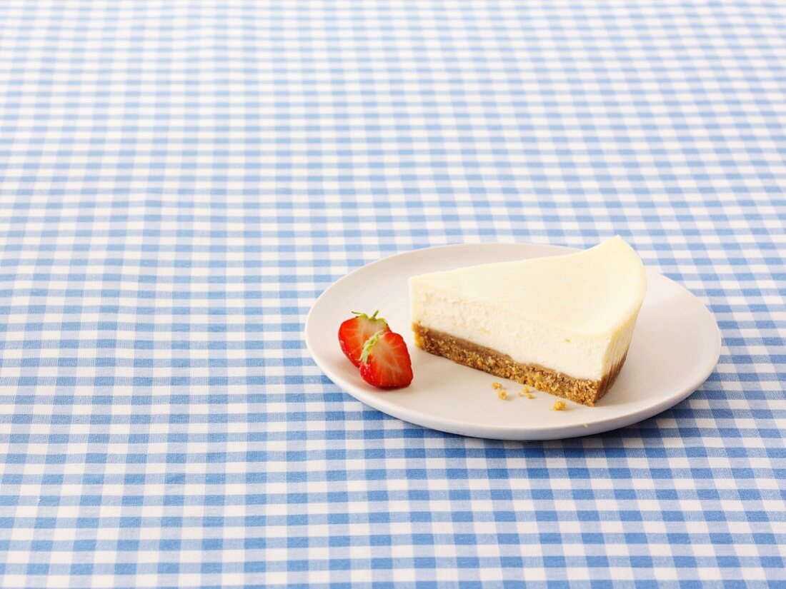 A slice of New York Cheesecake with strawberries