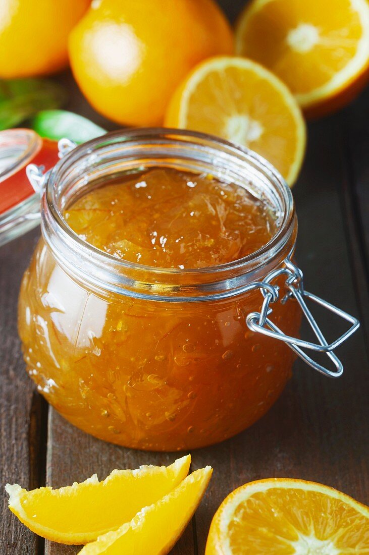 A jar of marmalade on a wooden surface