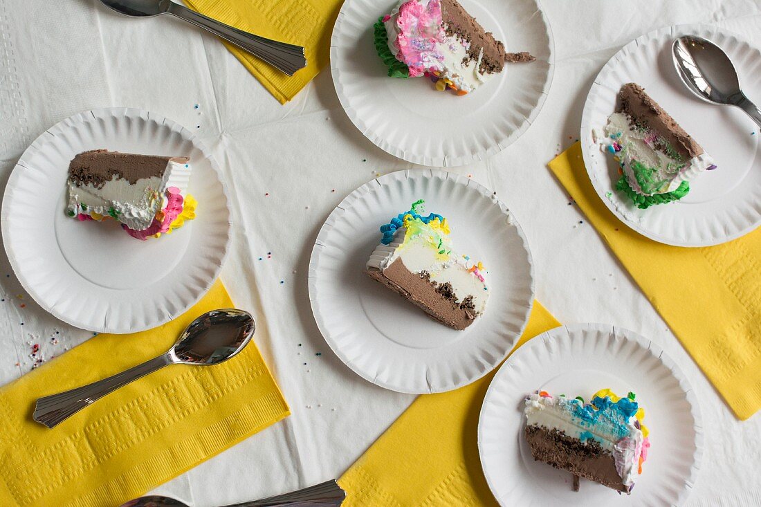 Slices of cream cake on paper plates