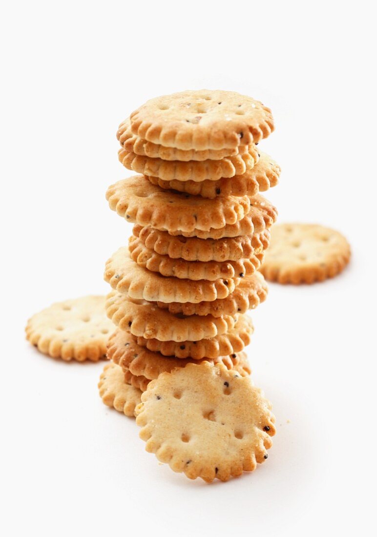 A stack of salted crackers on a white surface