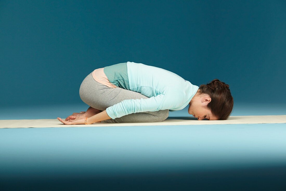 A young woman in the yoga mudra position