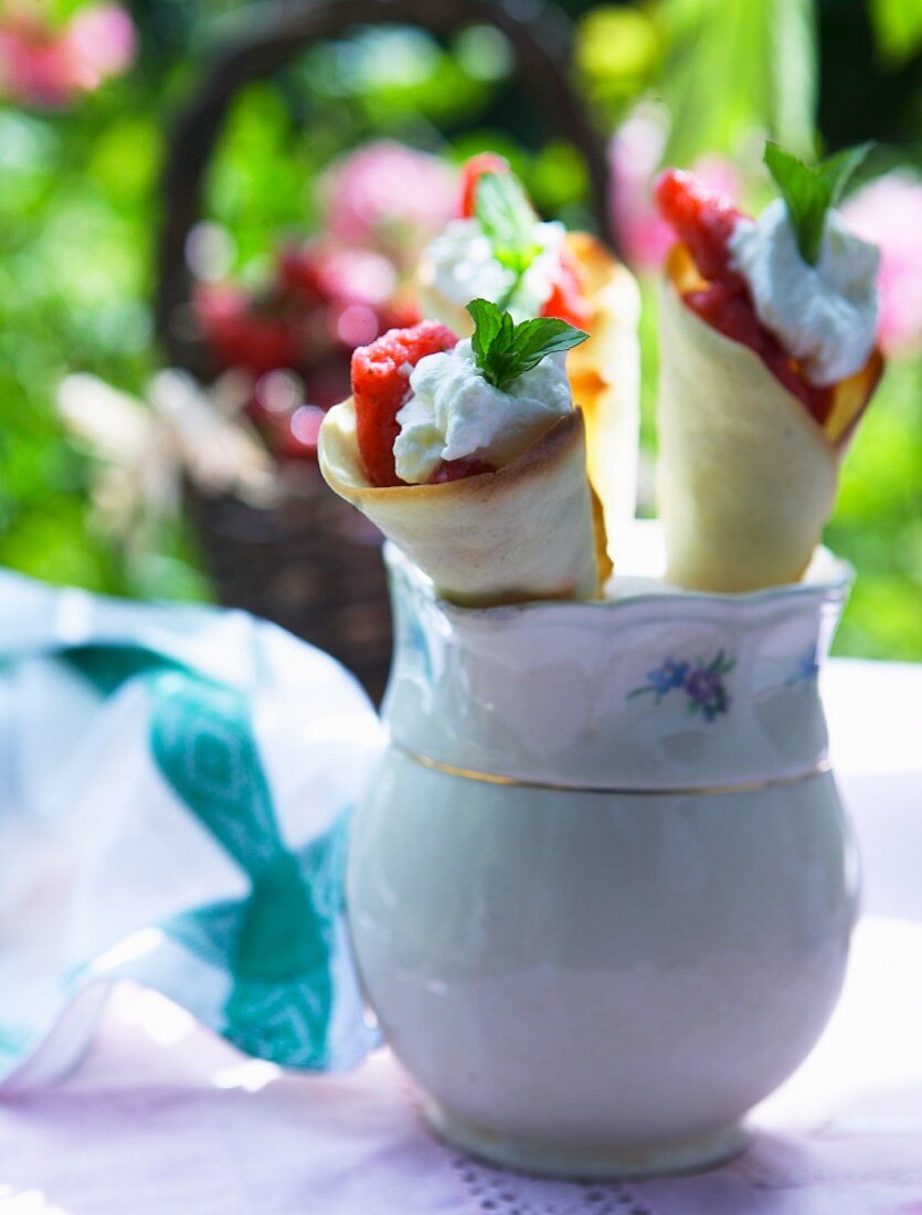 Crepe rolls filled with strawberries and cream