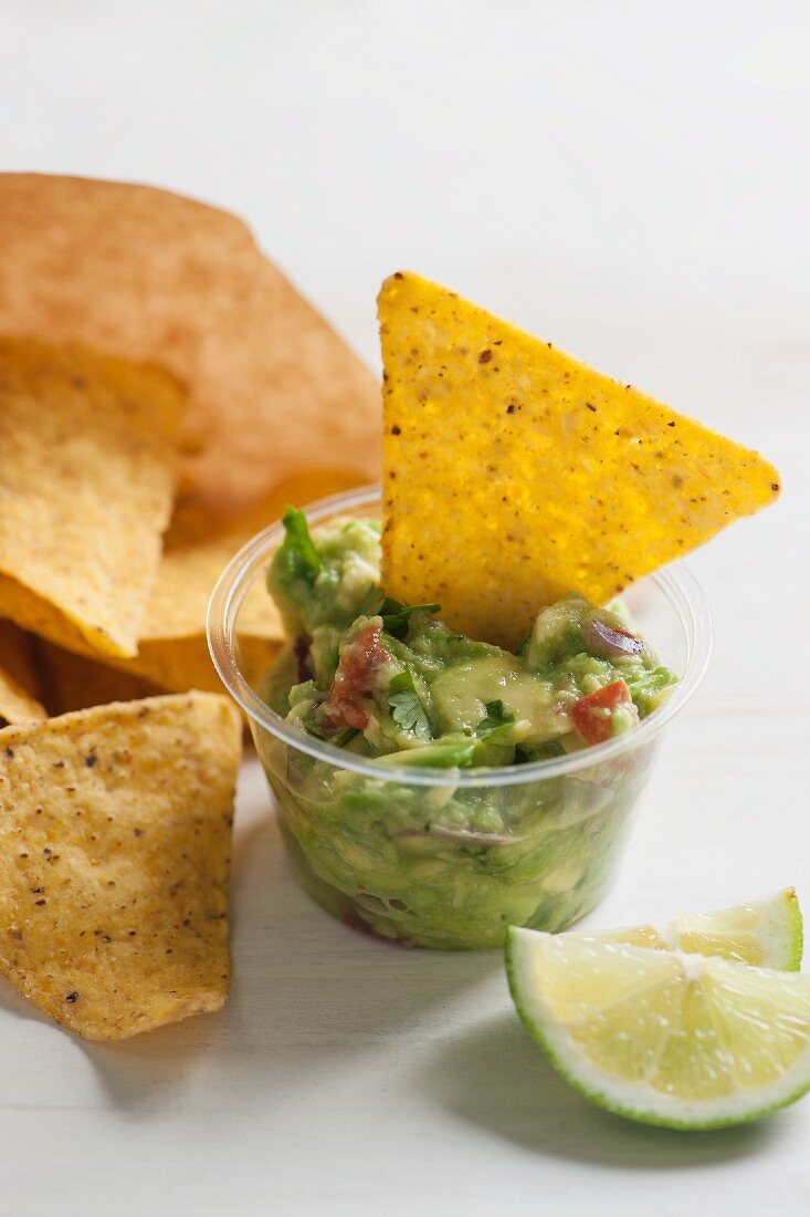 Guacamole with tomato piece and coriander served with tortilla chips
