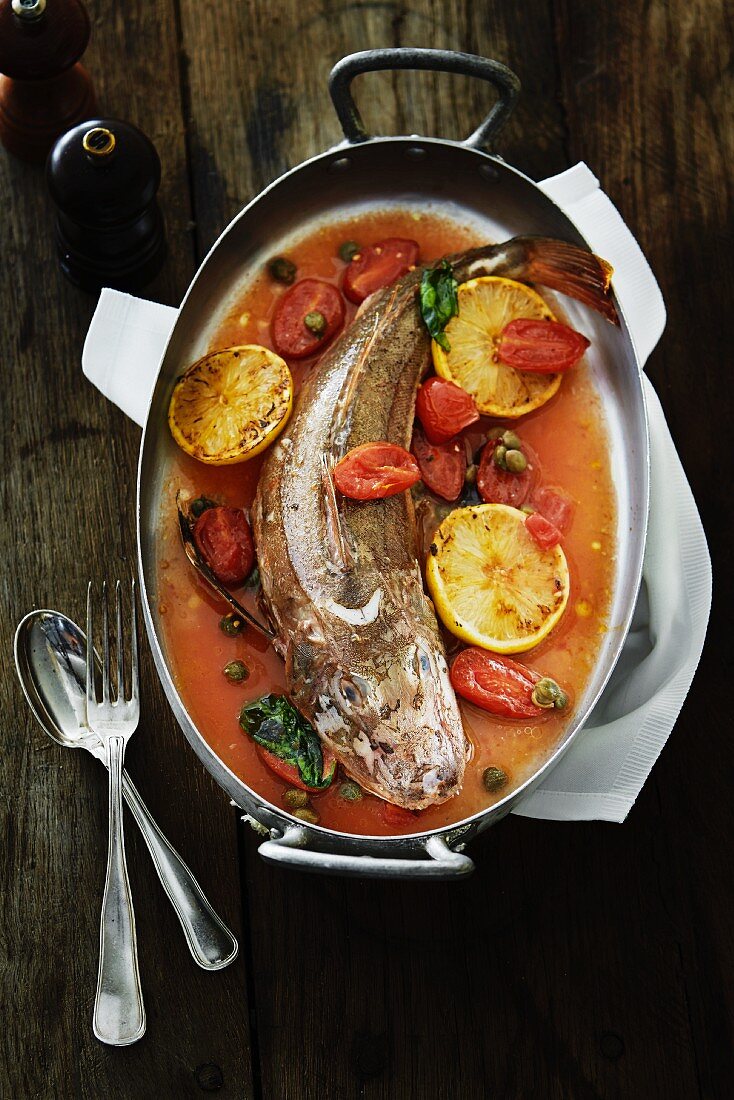 Fish with lemons and tomatoes