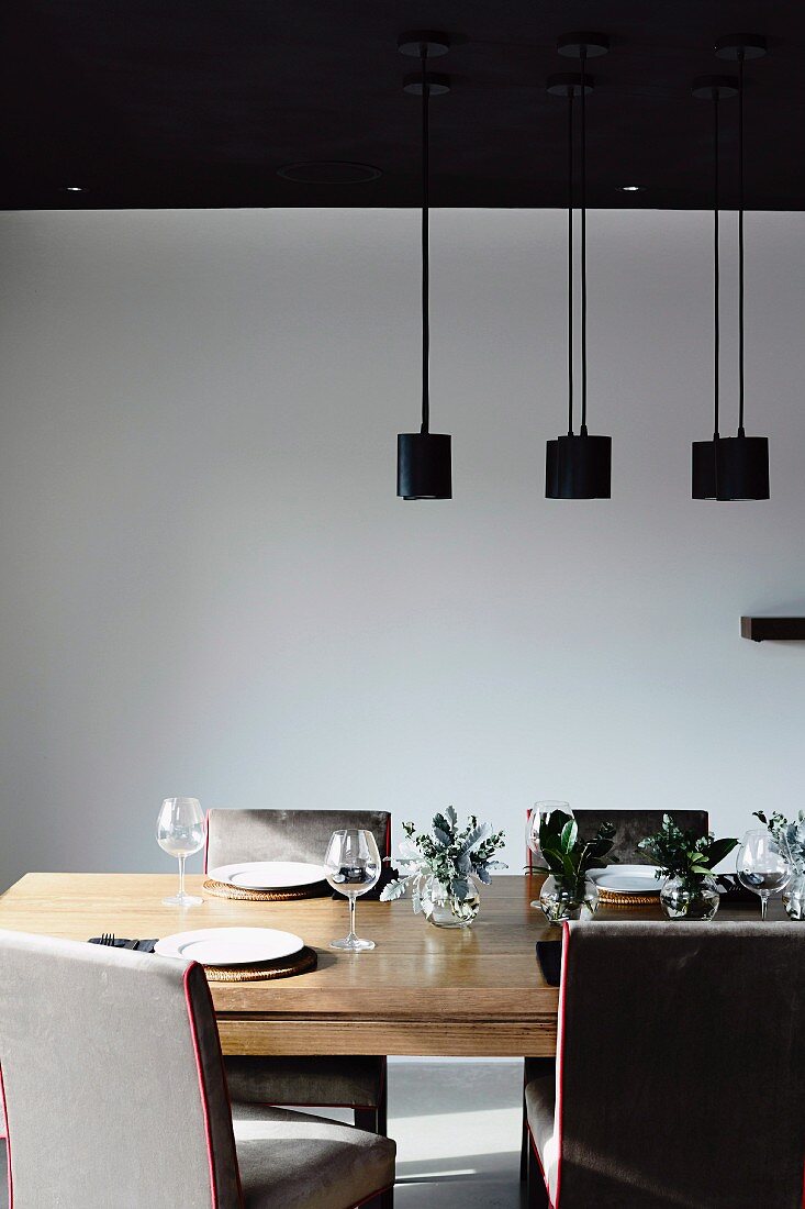 Pendant lamps above set modern dining table