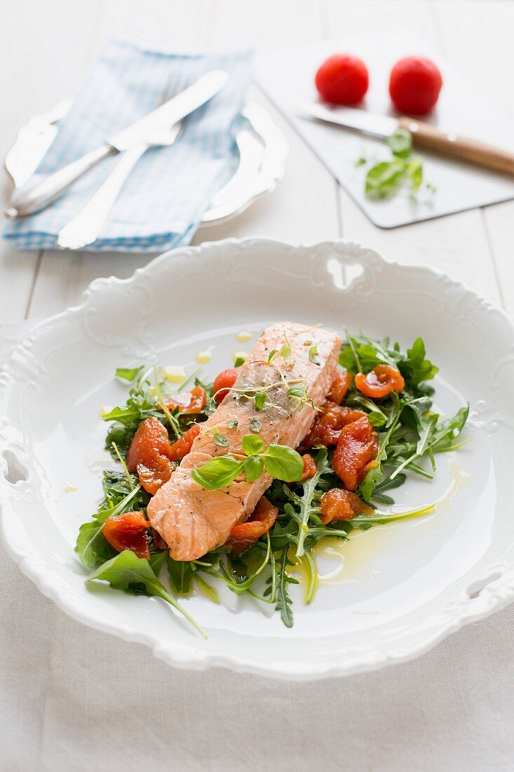 Steamed salmon on a bed of rocket