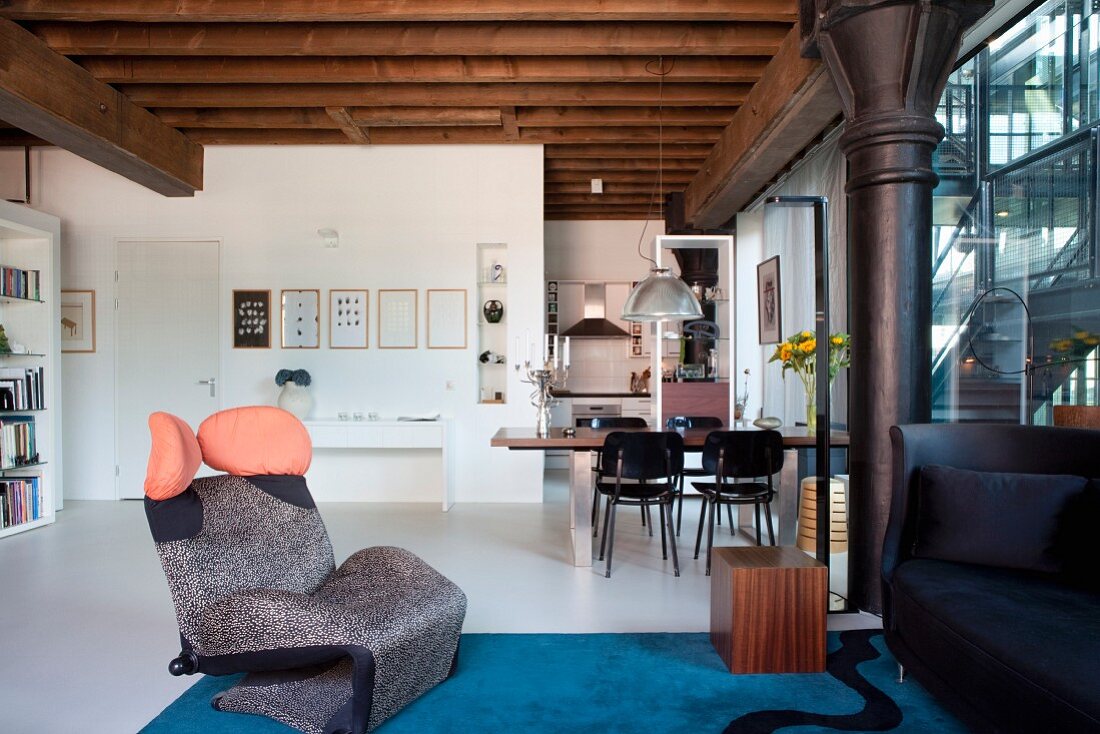 Wink Lounge Chair by Toshiyuki Kita in lounge area of loft apartment with dining area in background