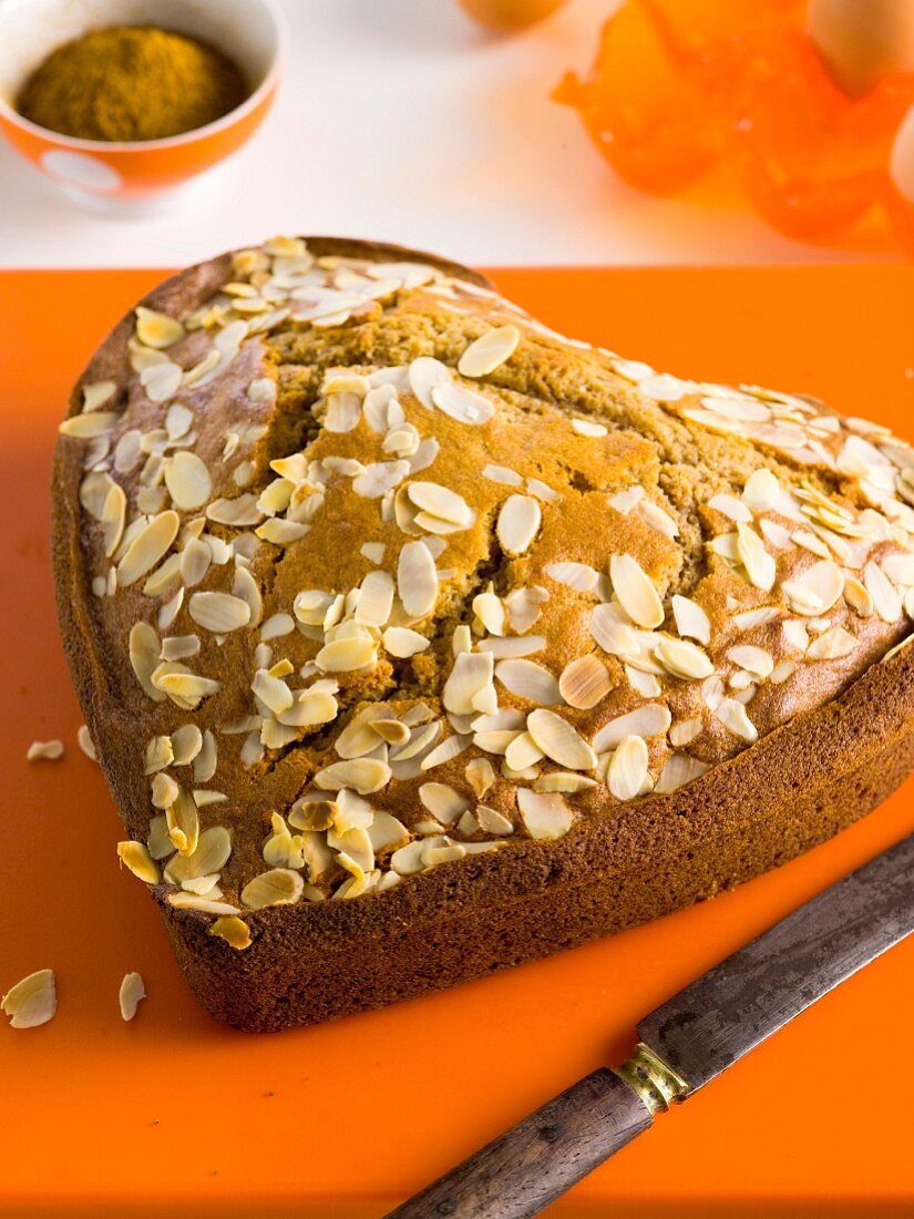 A heart-shaped marzipan cake with flaked almonds