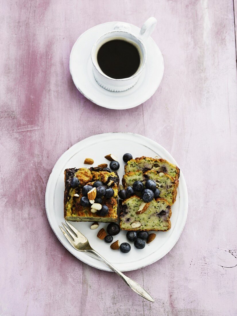 Mini blueberry and almond cake and a cup of coffee (seen from above)