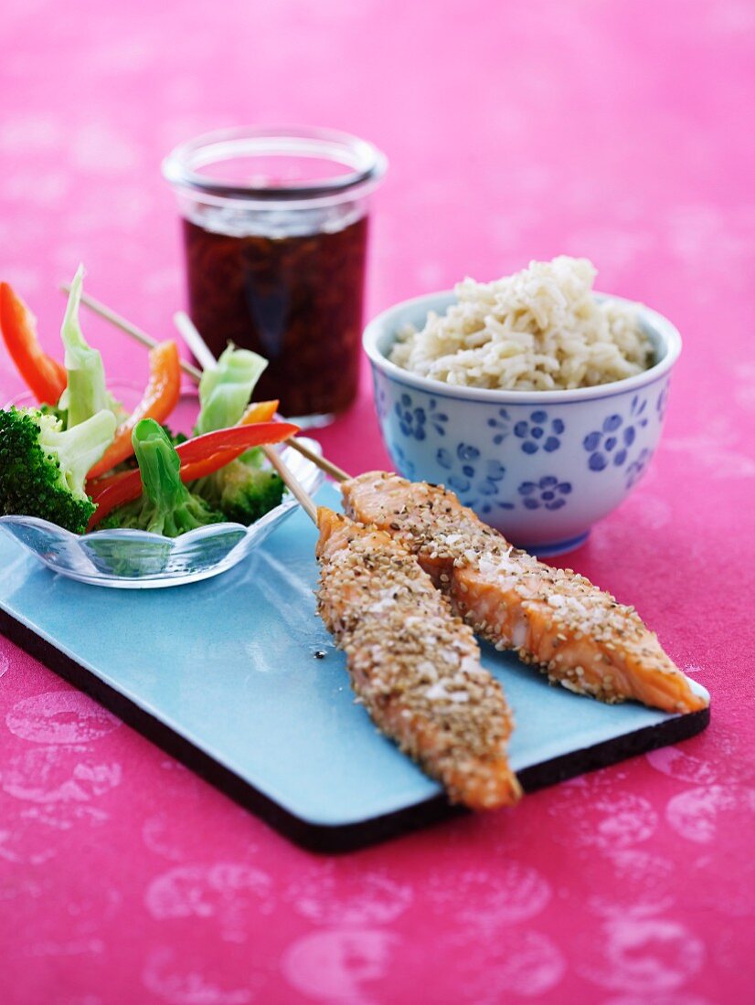 Sesame salmon skewers with rice and vegetables