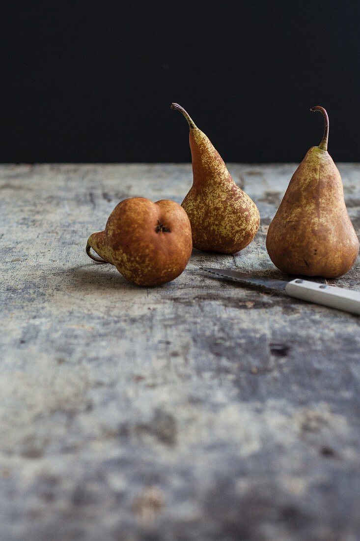 Three pears with a knife