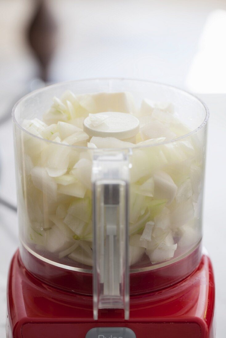 Onions being chopped in a food processor