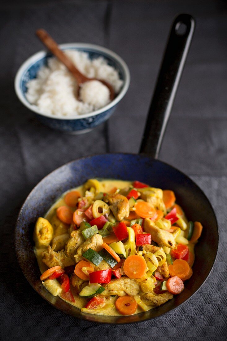 Bunte Currypfanne mit Hähnchen und Gemüse, dazu Reis
