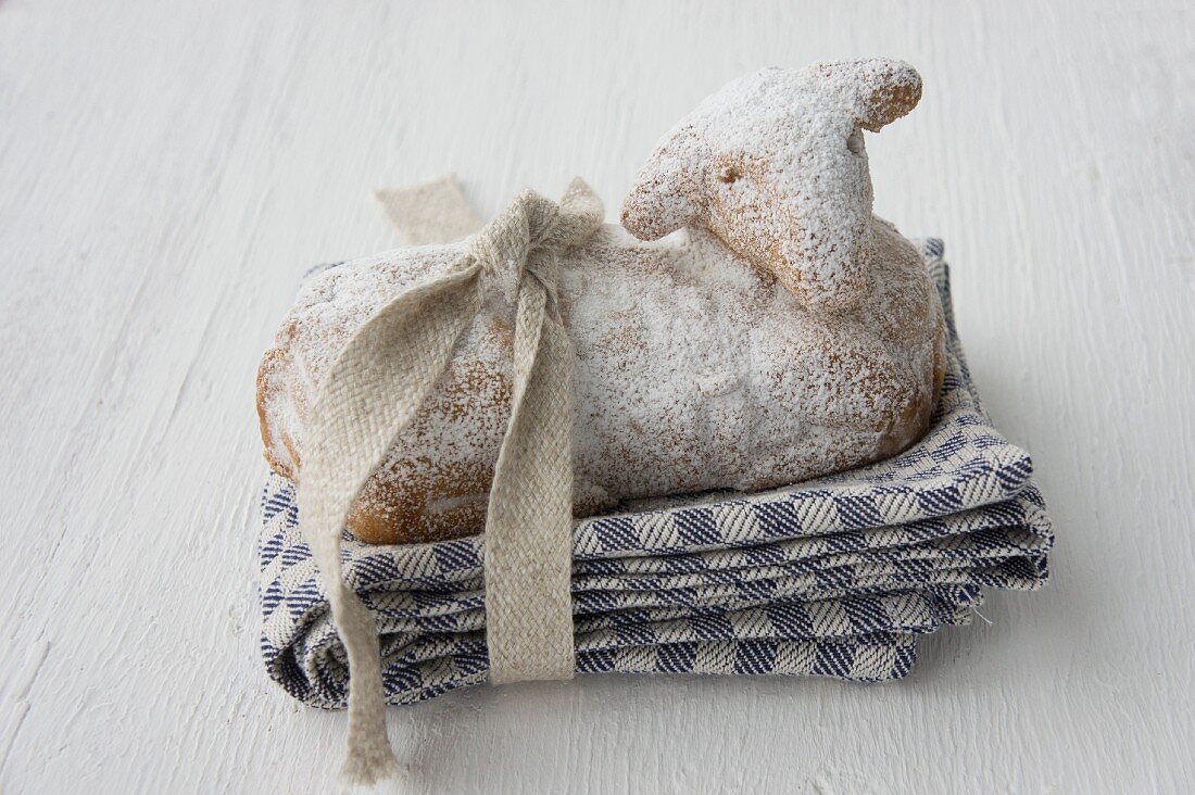 A sweet Easter lamb on a tea towel with a ribbon