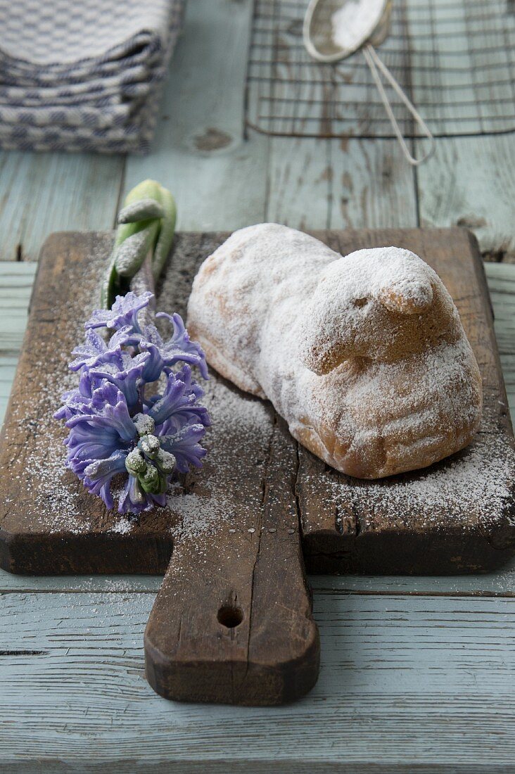 A sweet Easter lamb with hyacinths on a chopping board