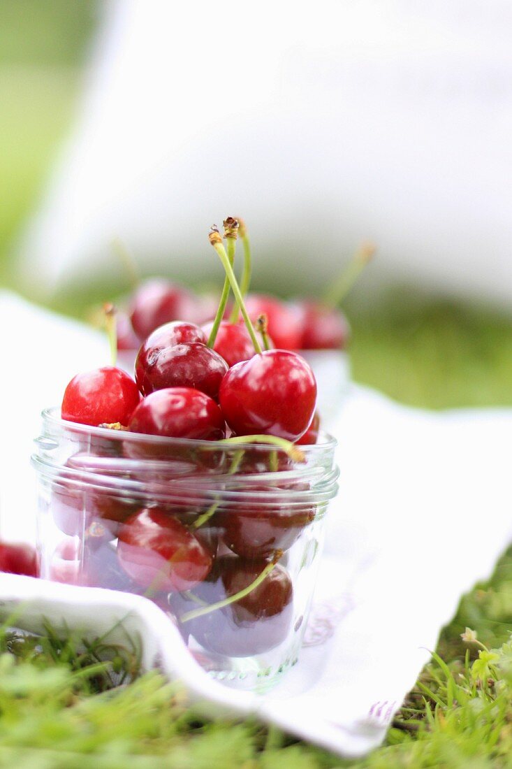 A jar of fresh cherries