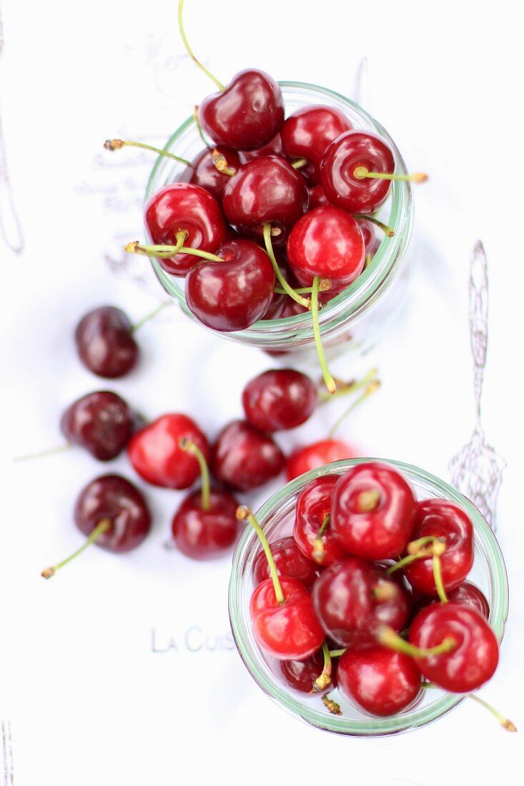 Fresh cherries in glasses and next to them