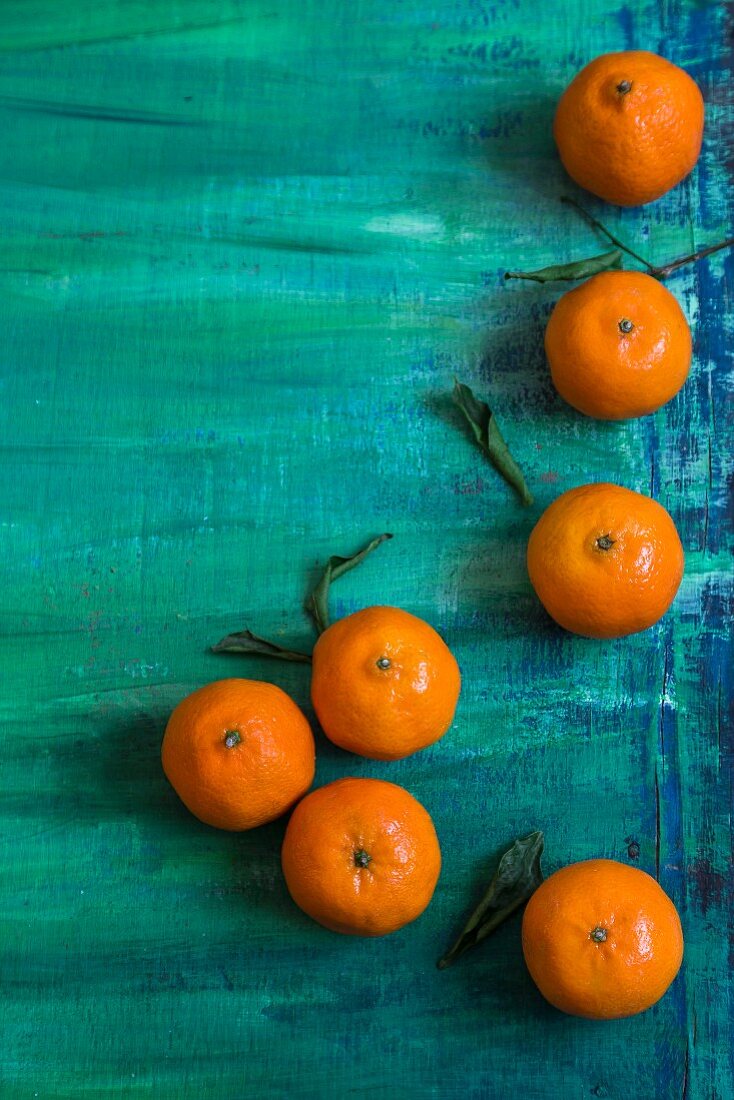 Clementines on a turquoise surface