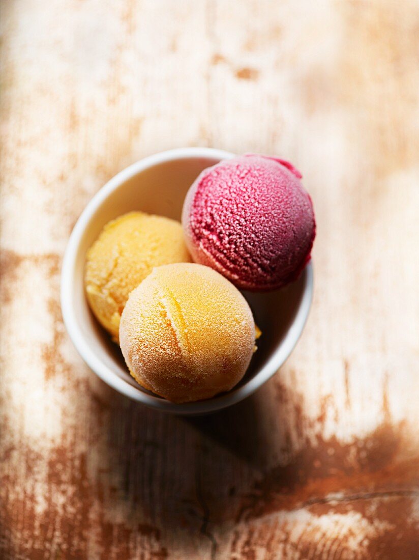 Mango ice cream and raspberry ice cream in a bowl