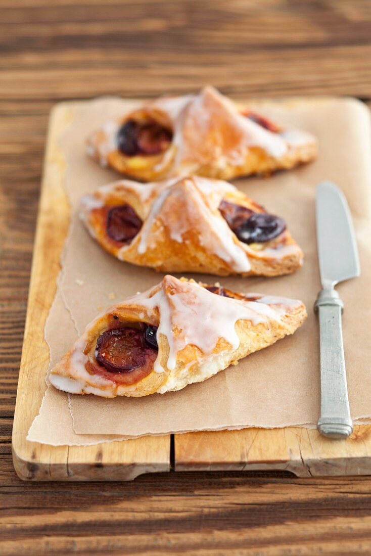 Puff pastries with plums and icing