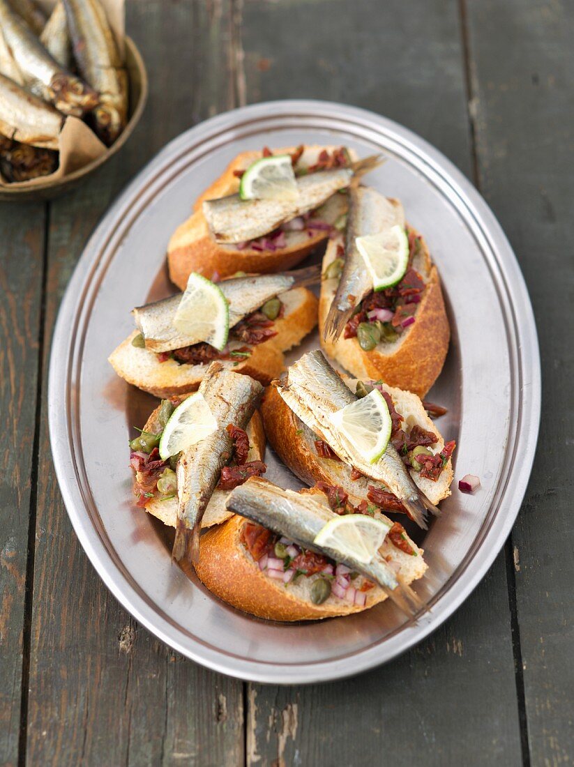 Baguette with smoked sprats and tomato salsa