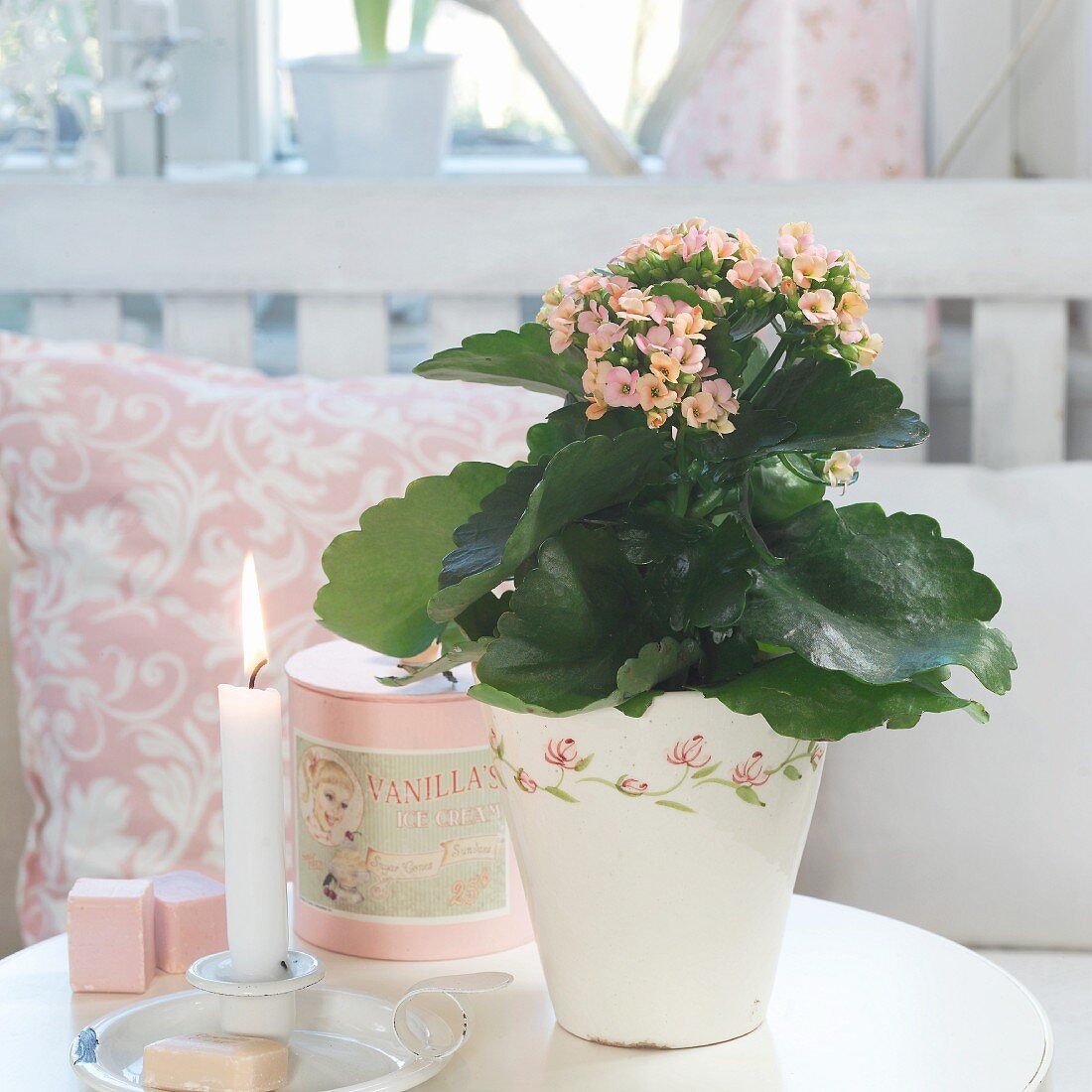 Flaming Katy in retro pot next to lit candle in metal candlestick