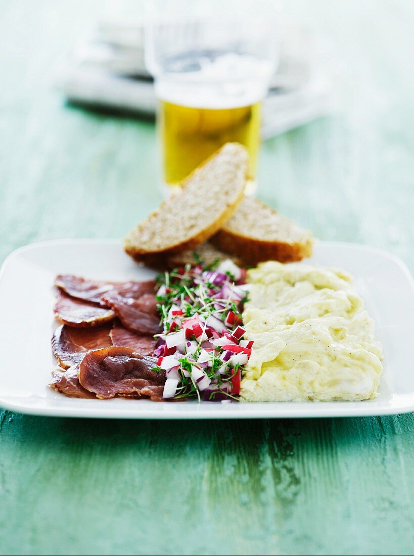 Smoked pork with radish and cress salad and scrambled egg