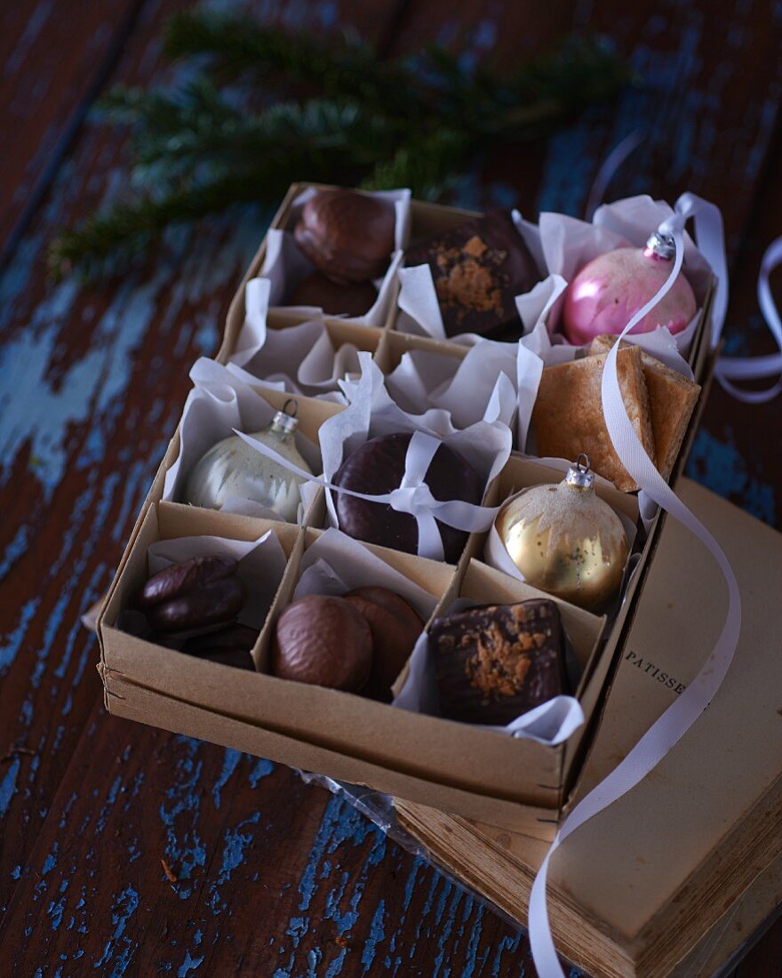 A box of various Christmas biscuits and Christmas tree decorations