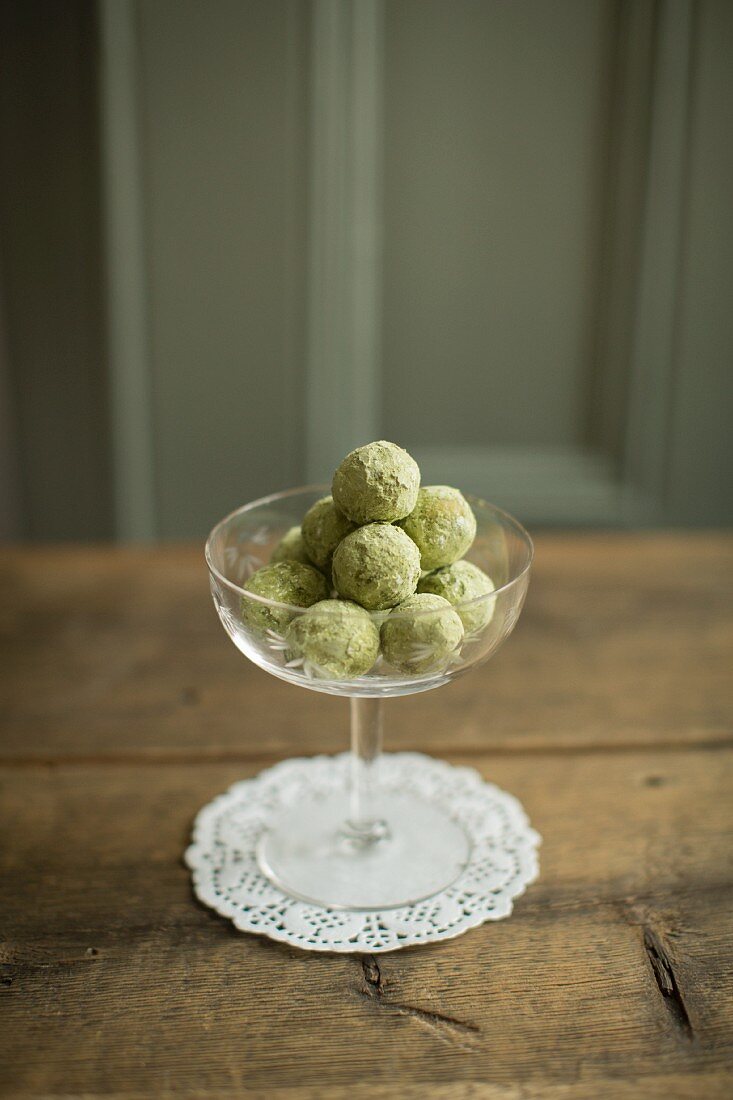 Matcha tea and chestnut truffles in a dessert bowl