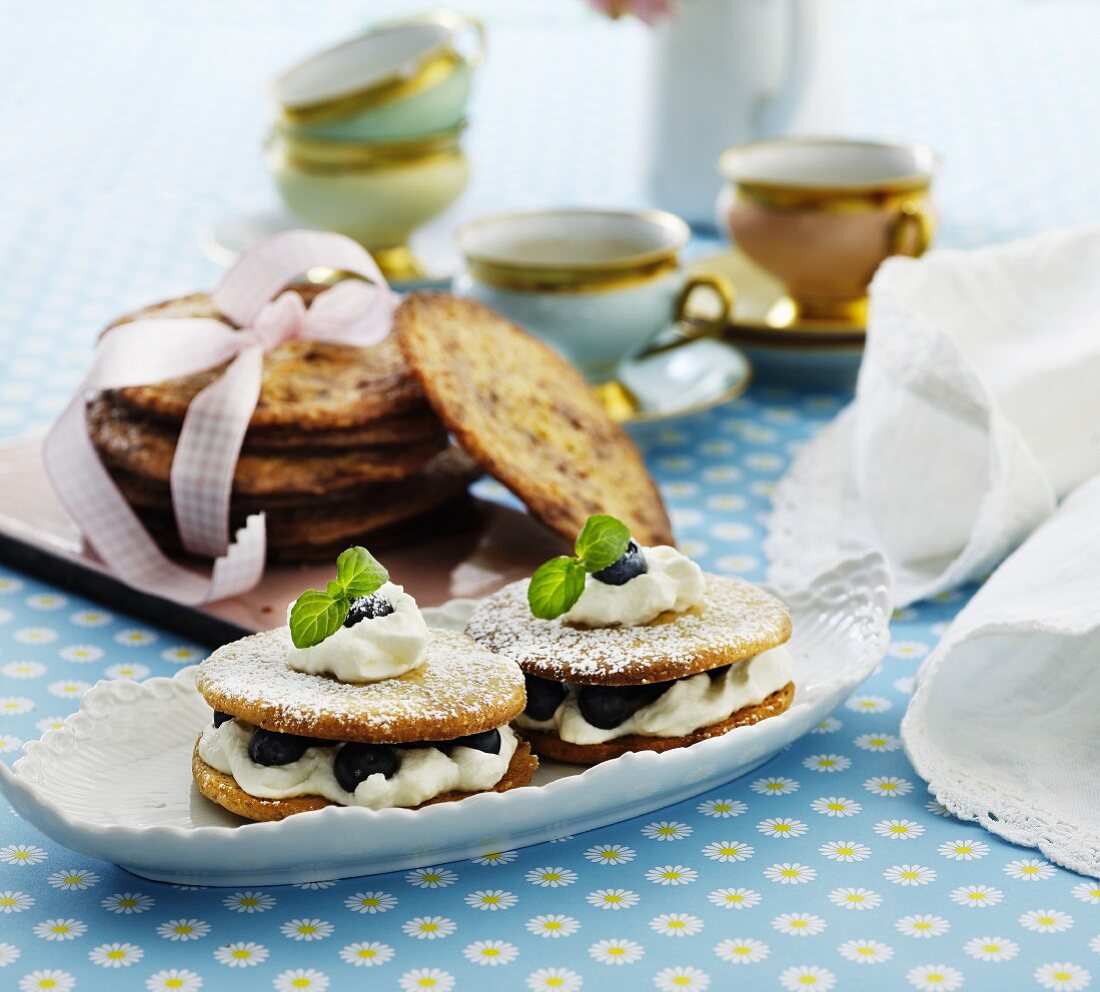Nut sandwich biscuits with cream and blueberries