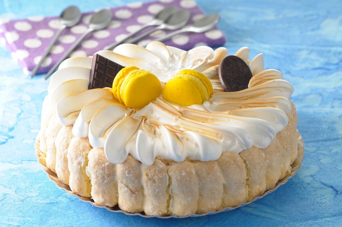 A lemon Charlotte topped with meringue and lemon macaroons