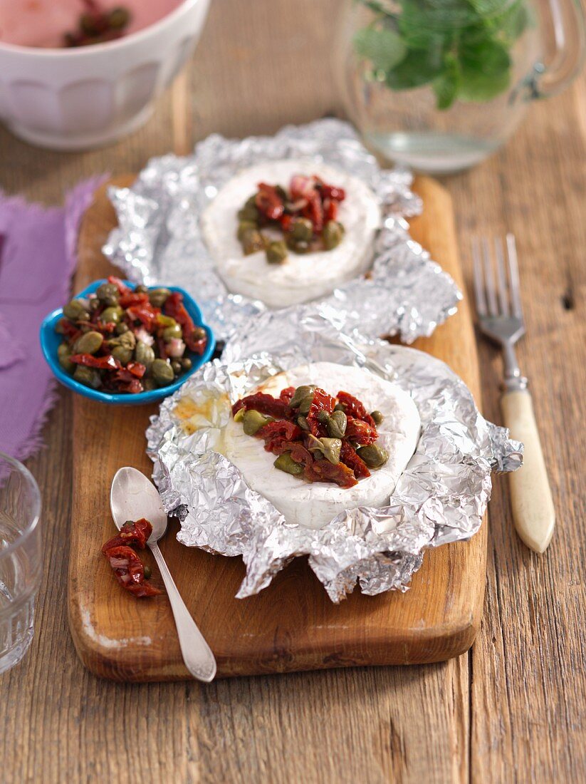 Camembert grilled in foil with dried tomatoes, capers and green peppers