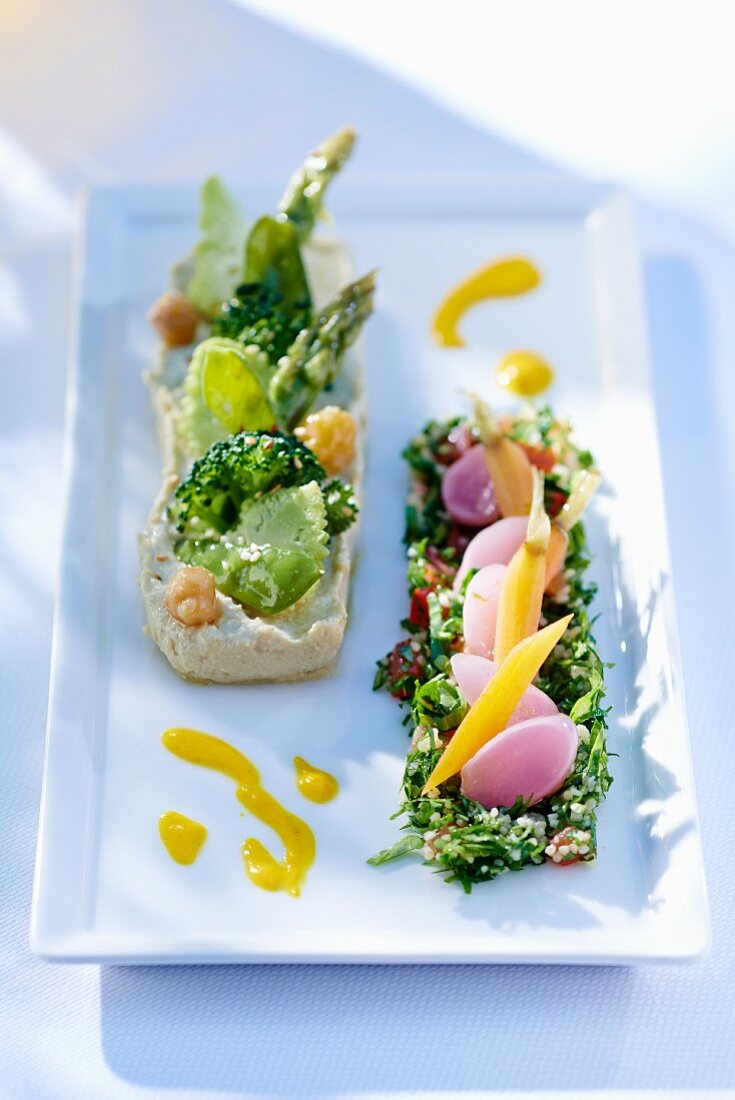 An appetiser platter with hummus and tabbouleh