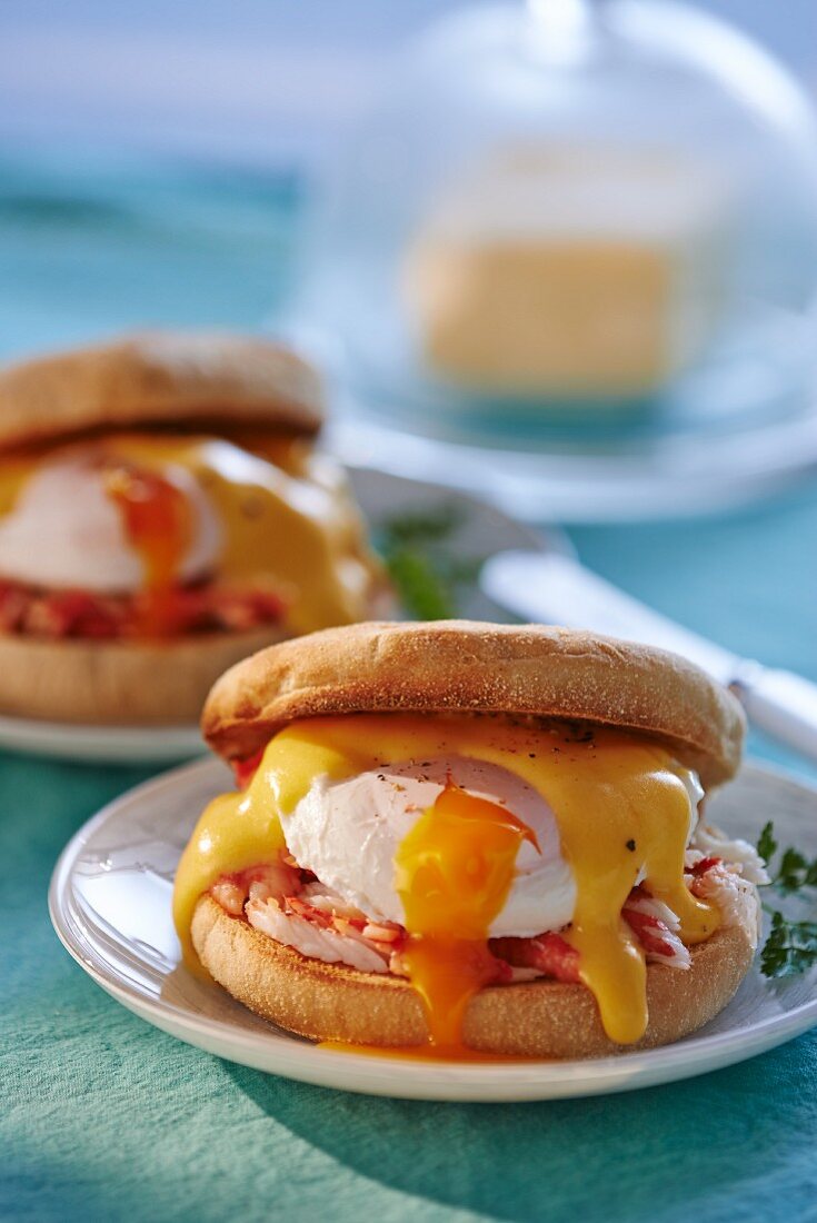 Eggs Benedict (muffins with poaches eggs and sauce Hollandaise)