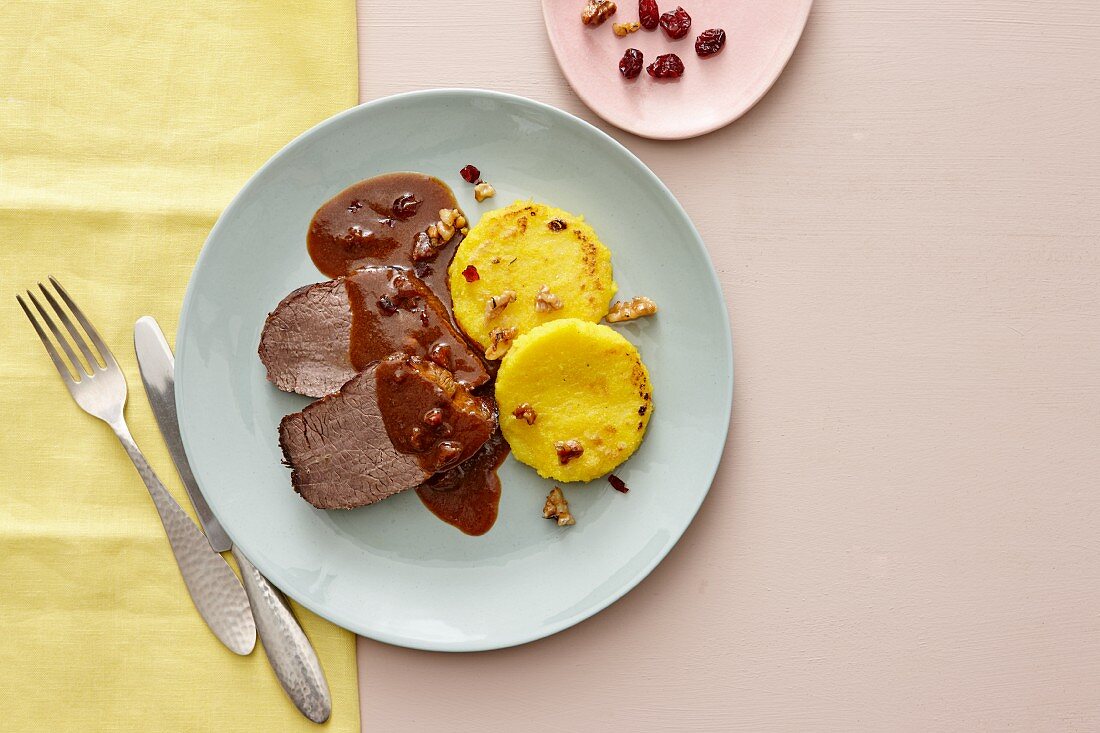 Roast beef with cranberry sauce, polenta and caramelised walnuts