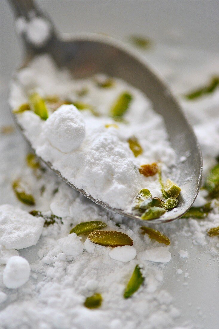 Icing sugar mixed with pistachios as baking ingredients